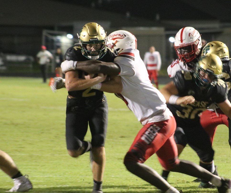 Marcus Stokes fights for yards on a quarterback keeper near the goal line.